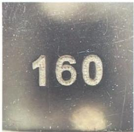 Hermès lock detail with "160" engraving, highlighting hardware finishing and font style.