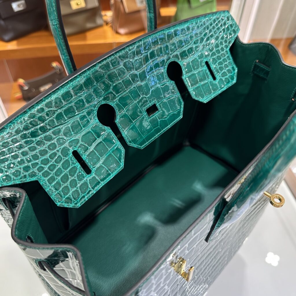 Interior view of a fully handmade Replica Handbag Store Birkin 35 Porosus replica showing flawless leather lining and hardware cutouts.