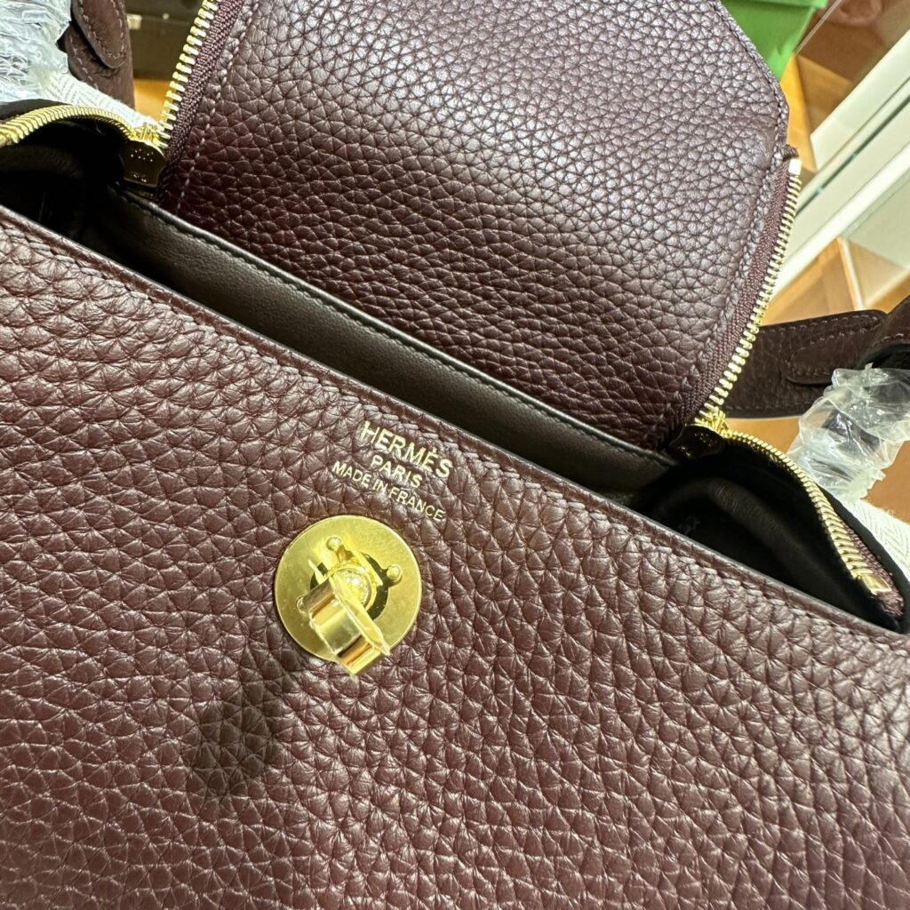Close-up of the crisp foil heat stamp and accurate turnlock placement on a premium Replica Handbag Store Mini Lindy replica.